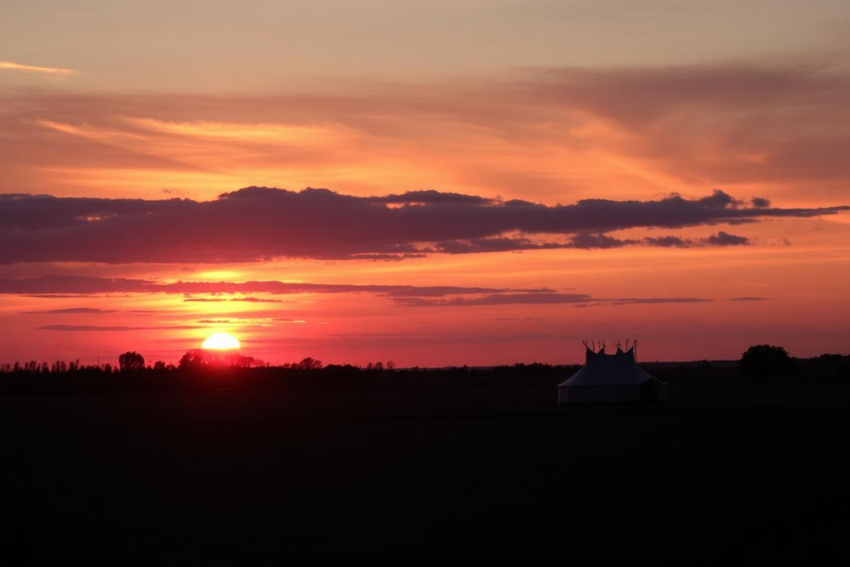 Tent silhouetted against a Norfolk sunset